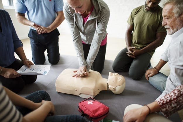 Group of diverse people in cpr training class cpr first aid course dublin - group of people learning how to resuscitate