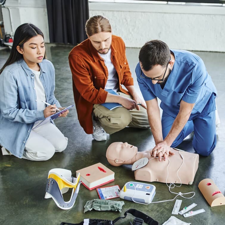 First aid training session in Dublin showing CPR and AED practice on a manikin