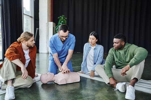 First Aid training in Dublin showing CPR practice on a manikin during a First Aid Responder course